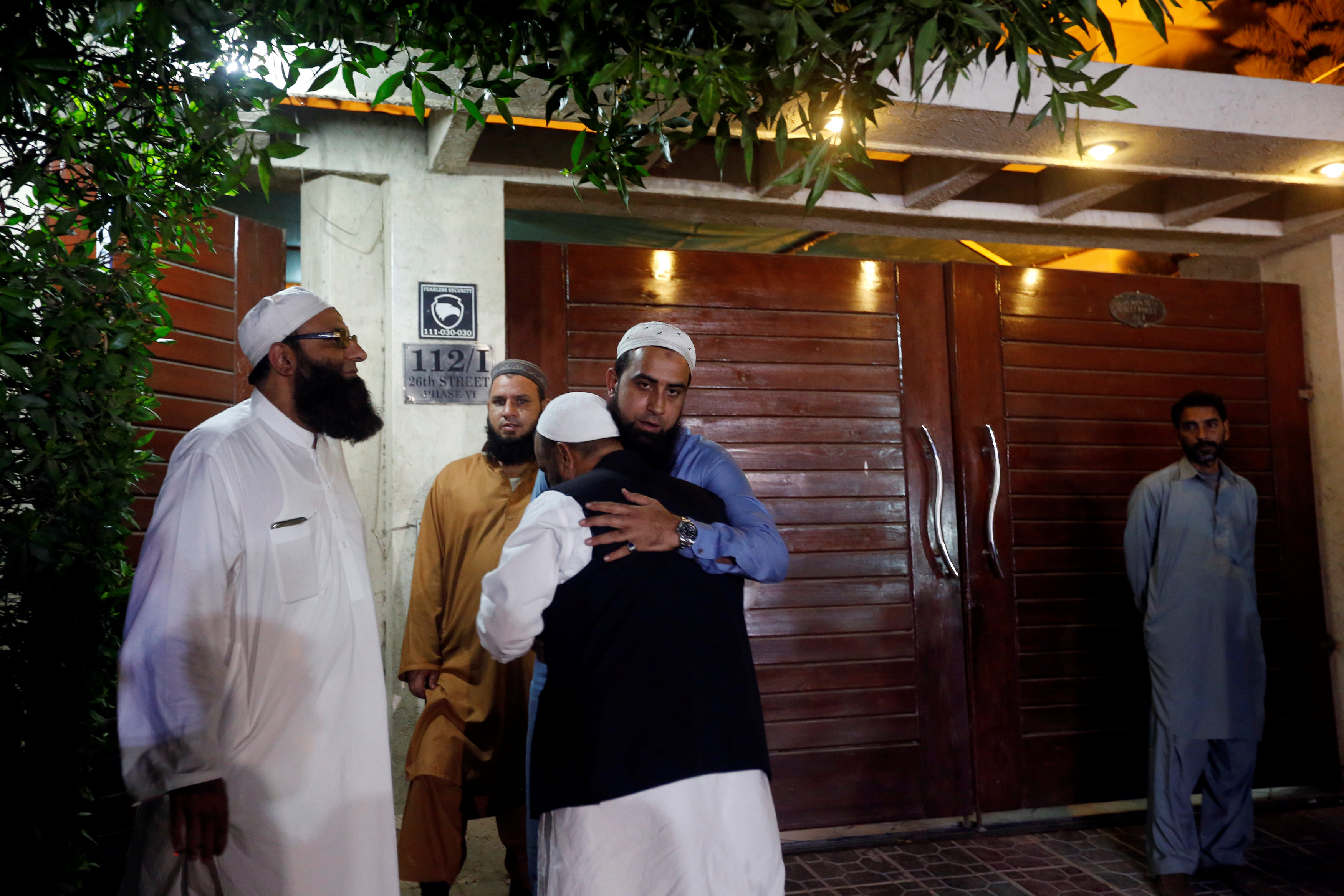 Relatives gather outside the residence of Junaid Jamshed, pop star turned evangelical Muslim cleric, in Karachi, Pakistan December 7, 2016. REUTERS/Akhtar Soomro