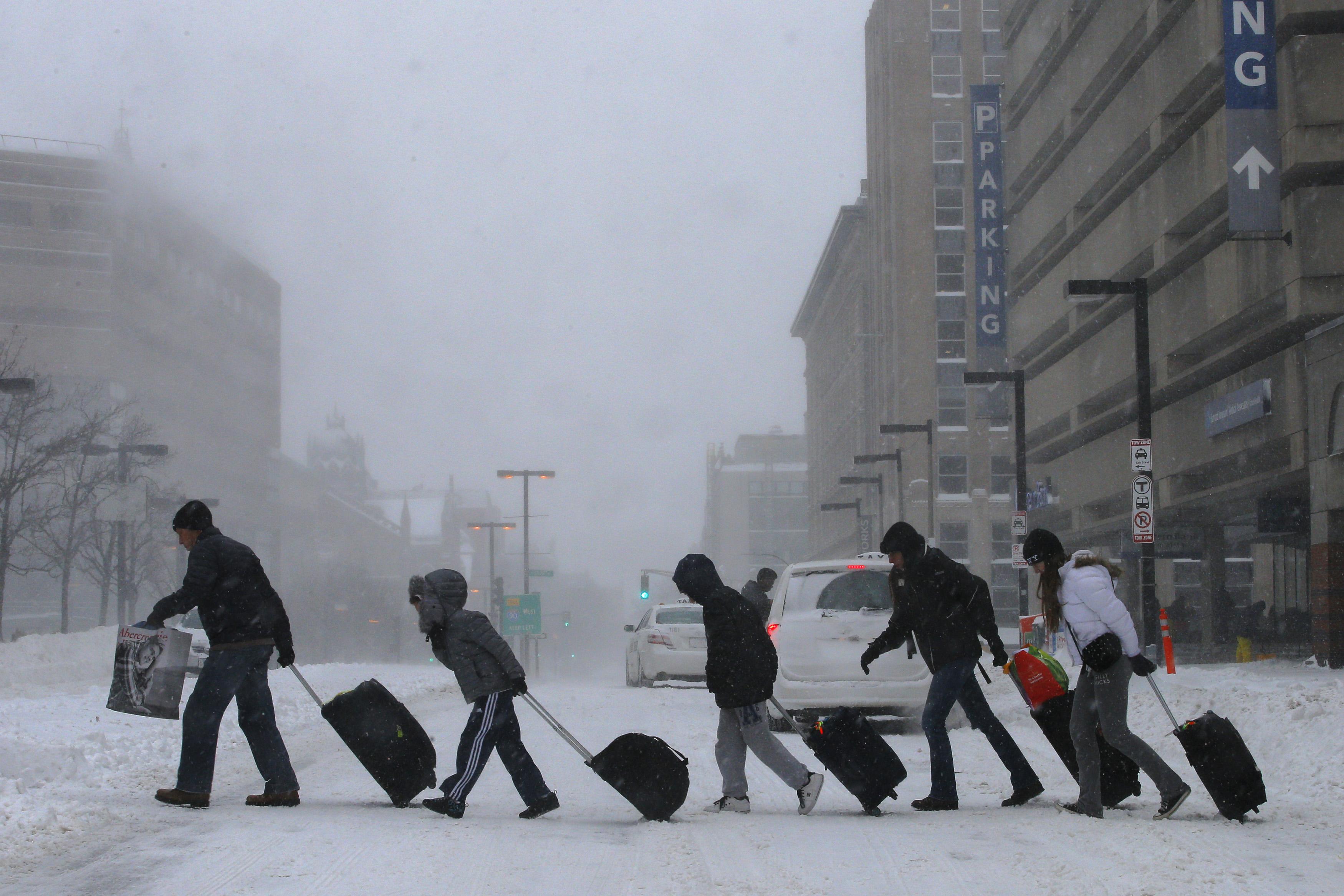Travelers leave the Back Bay train and subway station during a winter polar vortex snow storm in Boston, Massachusetts, U.S. on January 3, 2014.   REUTERS/Brian Snyder/File Photo