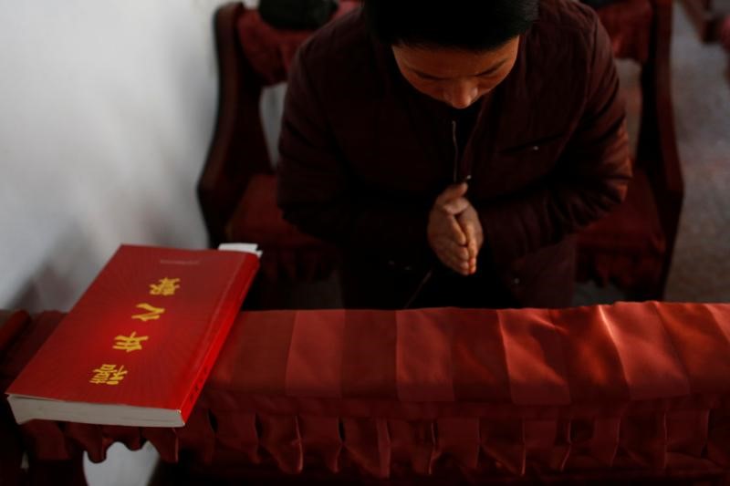 A man attends a service at the unofficial catholic church in Majhuang village, Hebei Province, China, December 11, 2016. Picture taken December 11, 2016. REUTERS/Thomas Peter