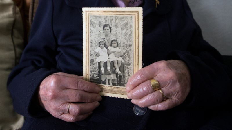 Esperanza Fernandez, 103, holds a picture of herself and her daughters, when she was young, in the living room of her home in Salamanca, central Spain, October 21, 2016. Fernandez lives with her daughters. Two of her sisters lived past 100 and another is about to celebrate her 100th birthday. She remembers when an outbreak of influenza killed nearly half of her village as a child. Her father shut the family in their house and prevented anyone from entering. REUTERS/Andrea Comas