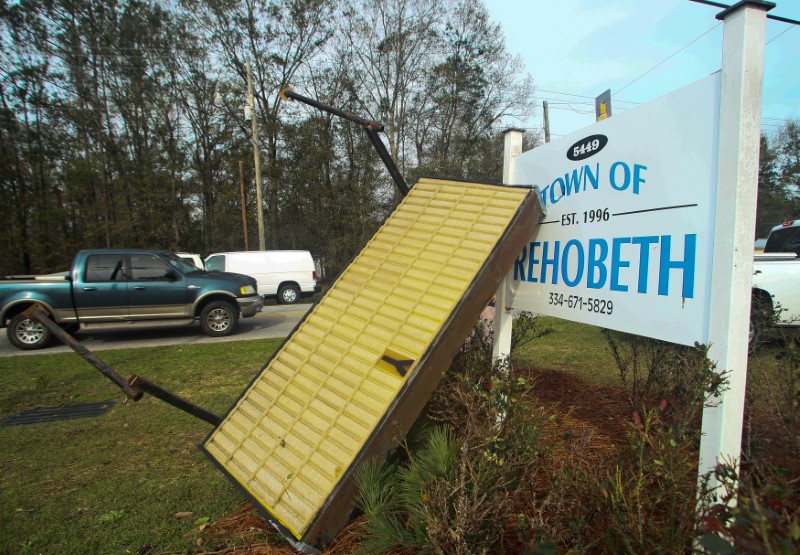 A sign blown down the road by a deadly storm rests against the town hall sign in Rehobeth, Alabama, U.S., January 3, 2017. REUTERS/Phil Sears