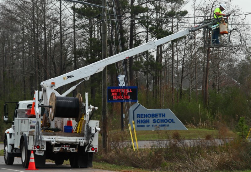 A utility worker restores power near Rehobeth High School after a deadly storm in hit Rehobeth, Alabama, U.S., January 3, 2017.  REUTERS/Phil Sears