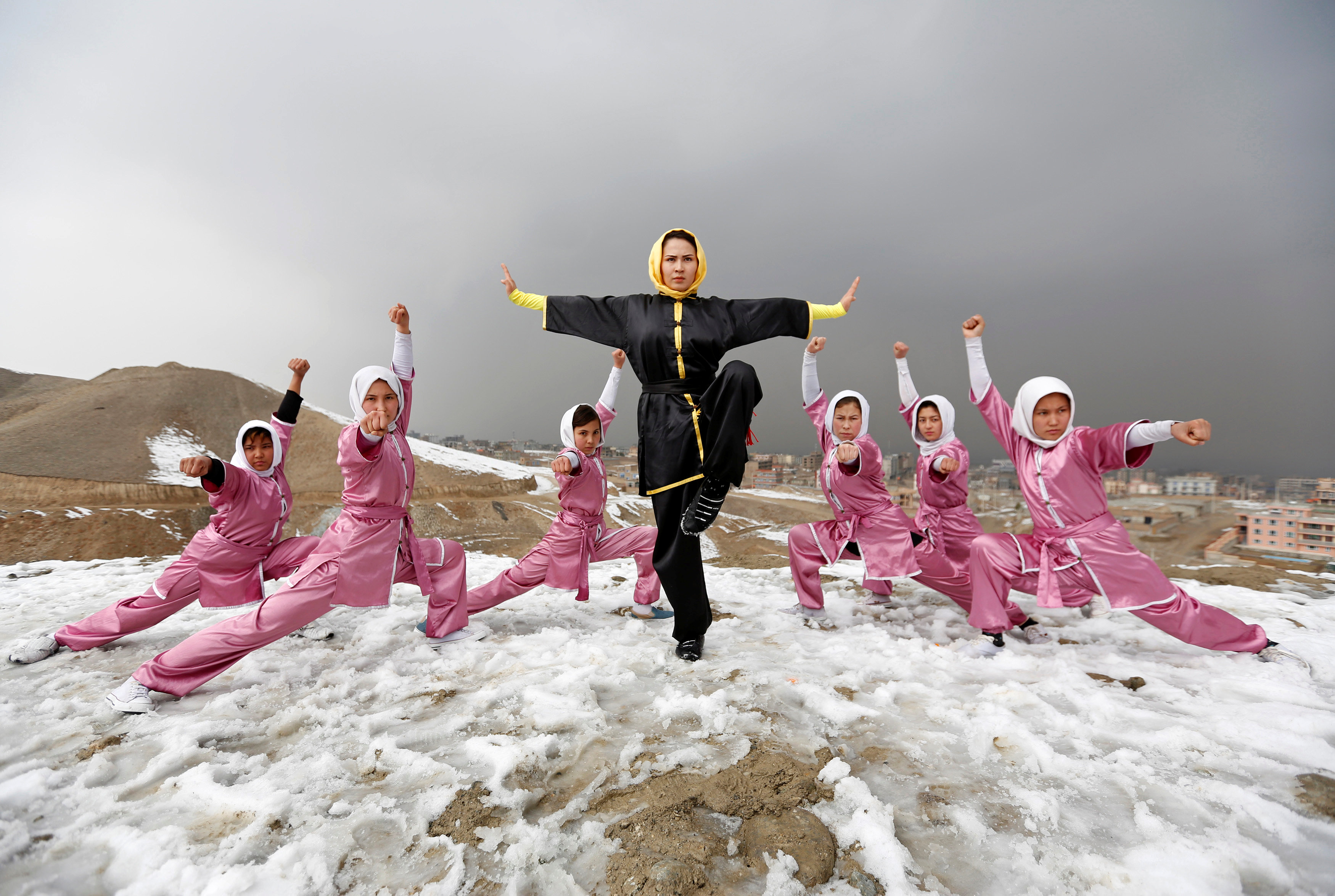 Sima Azimi (C), 20, a trainer at the Shaolin Wushu club, poses with her students after an exercise on a hilltop in Kabul, Afghanistan January 29, 2017. REUTERS/Mohammad Ismail