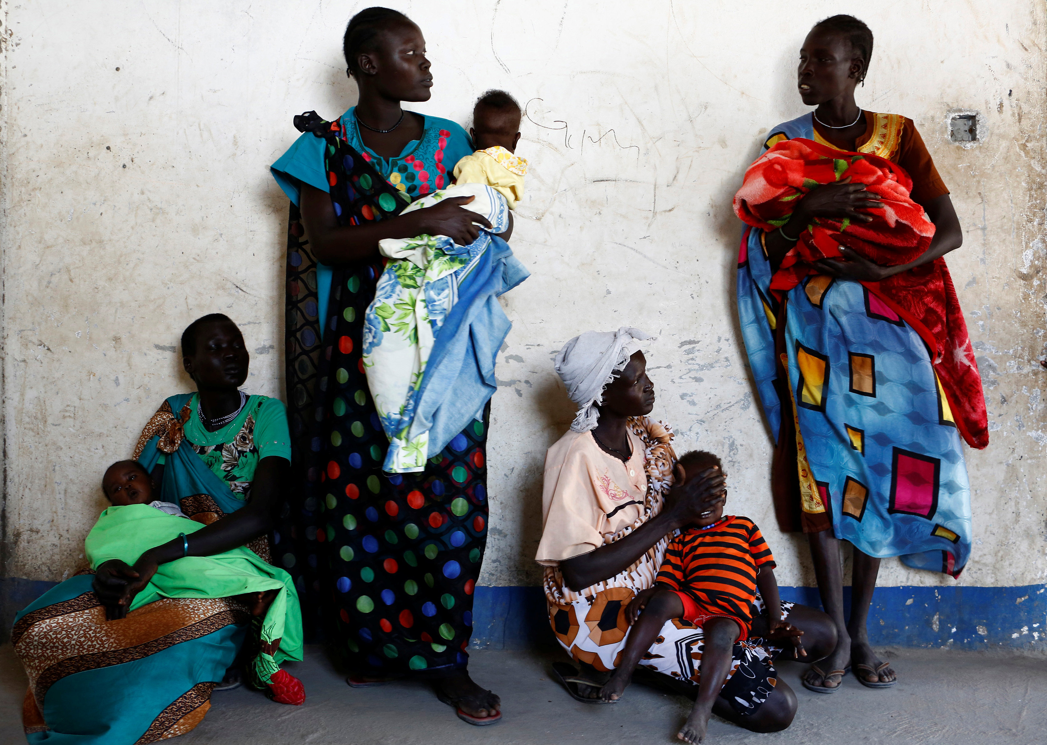 Women hold their babies as they wait for a medical check-up at a United Nations International Children's Fund (UNICEF) supported mobile health clinic in Nimini village, Unity State, South Sudan February 8, 2017. REUTERS/Siegfried Modola