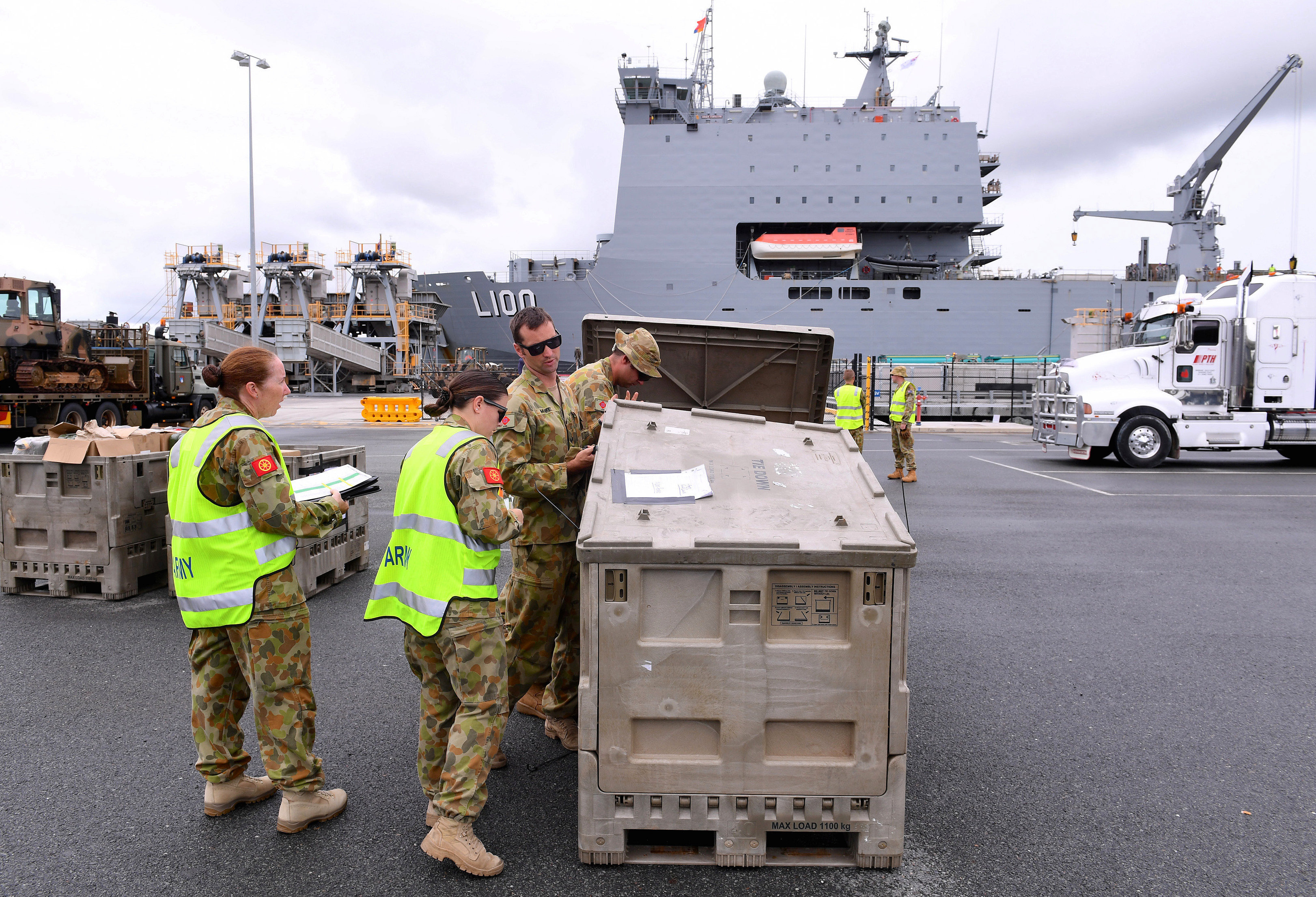 Emergency relief supplies for those affected by Cyclone Debbie are loaded onto the Royal Australian Navy Ship HMAS Choules at the Port of Brisbane in Australia, March 29, 2017.   AAP/Dave Hunt/via REUTERS
