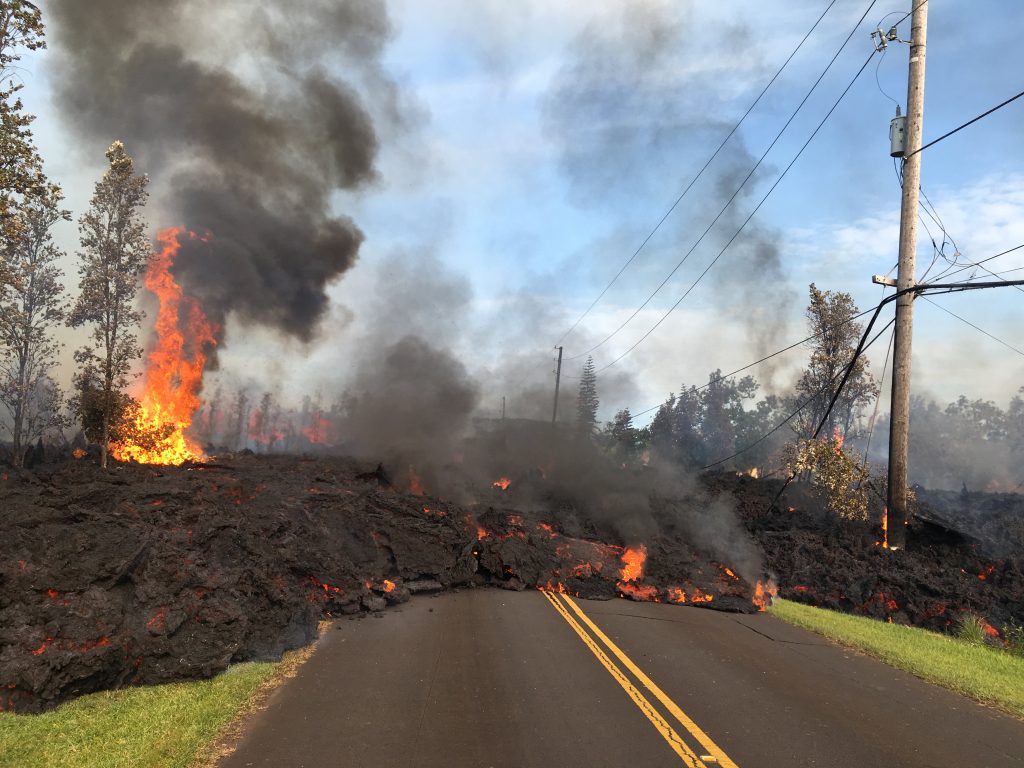 Lava advances along a street near a fissure in Leilani Estates, on Kilauea Volcano's lower East Rift Zone, Hawaii, the U.S., May 5, 2018. U.S. Geological Survey/Handout via REUTERS