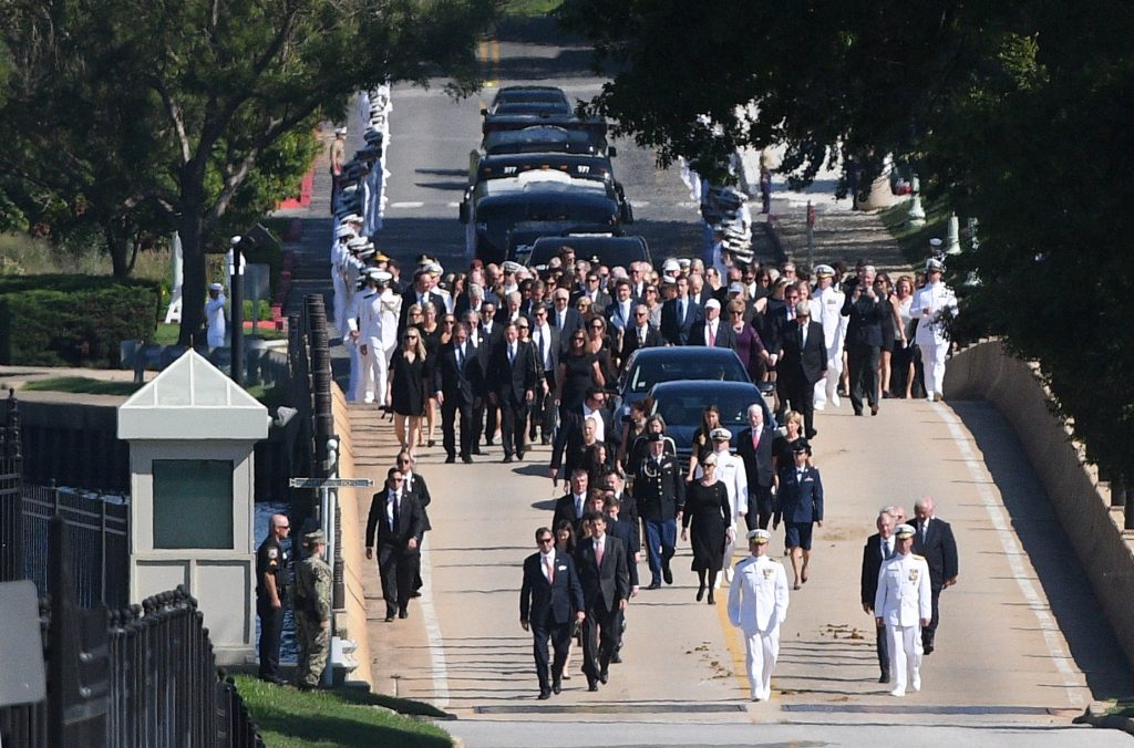 A hearse containing the body of the late Senator John McCain arrives for a private memorial service and burial at the U.S. Naval Academy  in Annapolis, U.S., September 2, 2018. REUTERS/Mary F. Calvert