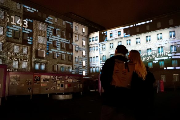 People stand in front of a projection on the former Stasi secret police headquarters in Berlin, Germany, November 4, 2019. On November 9th Germany will mark the 30th anniversary of the fall of the Berlin Wall (Berliner Mauer) in 1989. REUTERS/Fabrizio Bensch